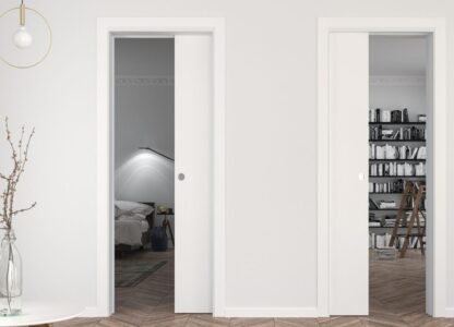 Two white sliding doors going into rooms