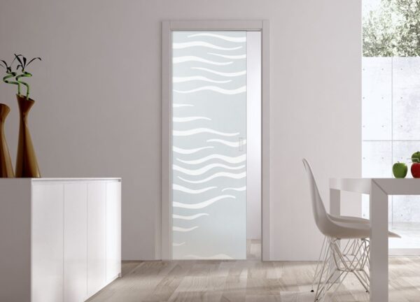 A modern minimalist room with an ECLISSE Pocket Door Systems Classic Single Glass Door (10mm, patterned), white walls, light wood floor, white furniture, and two tall vases on a side cupboard.