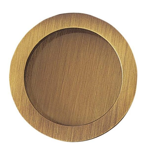 A round, flat, brass-coloured metal plate with a brushed texture, the Flush Pull Round Handle - Dia 57mm is an elegant detail often featured in ECLISSE Pocket Doors and Sliding Doors systems.
