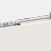 A close-up view of the ECLISSE BIAS® DS Bi-directional Soft-Close sliding door mechanism mounted atop a white door, displaying detailed metal components and track against a light background.