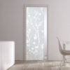 A modern room features an ECLISSE Pocket Door System with a patterned glass door, white furniture, two tall vases, a fruit-topped table, and a white chair beside a large window.
