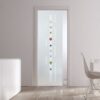 An ECLISSE Pocket Door Systems Classic Single Glass Door (10mm, patterned) with frosted glass and coloured vertical and diamond accents separates a modern minimal room featuring white furniture and light wood flooring.