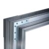 A close-up of the ECLISSE Pocket Door System - Syntesis® Single Wiring-Ready metal frame corner, joined by a silver L-shaped bracket and screws, highlighting the structure and connection details against a white background.
