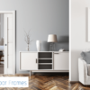 A modern living room with grey walls, white sofa, sideboard, and lamp features a framed FD30 Approved fire safety sign and Rocket Door Frames logo. A partially open sliding door reveals a bedroom with the 75mm Fire Rated Pocket Door Kit.