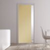 A modern, minimalistic room featuring the ECLISSE Pocket Door Systems - Classic Single Coloured Glass Door 10mm in light yellow, white walls, a white cabinet with vases, a white dining table and chair by a large window.