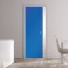 A modern room with light wood floors, white walls, and an ECLISSE Pocket Door Systems - Classic Single Coloured Glass Door 10mm in blue. White cupboards on the left display two tall vases; a white dining table and chair are on the right.