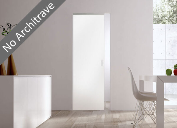 A modern, minimalistic room features a white ECLISSE sliding pocket door with no visible architrave. The space includes a white table, chair, and a window streaming in natural light. Text overlay reads No Architrave.