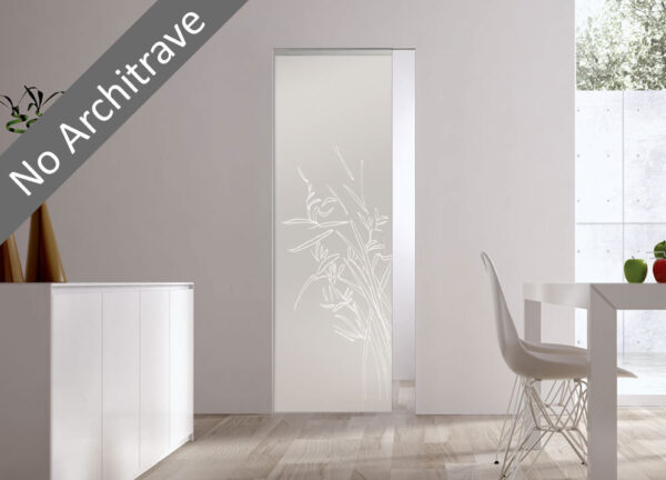A minimalist interior features the ECLISSE Syntesis® 10mm Flush Glass Pocket Door System with floral patterns, seamlessly set into a white wall without architrave. A modern dining table and chair sit on the right as natural light fills the room.