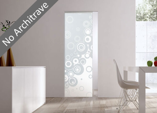 Modern minimalist space with the ECLISSE Syntesis® 10mm Flush Glass Pocket Door System (Plain or Patterned) featuring a circular design and no architrave. Shown with a white table, chair, and green/red decor. Text: No Architrave.