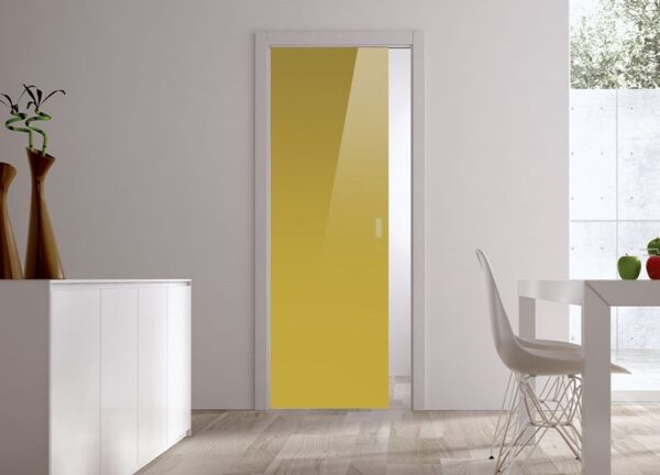 A modern room with an ECLISSE Pocket Door Systems Classic Single Glass Doors (10mm), yellow, white walls, light wood floor, white sideboard with brown vases, a white dining table and chair. A window shows a bright outdoor scene.