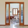 ECLISSE Classic Double Pocket Door Kit with frosted glass panels opens to a modern kitchen featuring a window, white dining table, and chairs on a speckled floor filled with natural light.