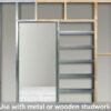 An ECLISSE Pocket Door System - Classic Double Plain Satin 8mm Glass with Stainless Steel Round Handle, shown installed in a wall, is compatible with metal or wooden studwork. Perfect for ECLISSE Pocket Doors.