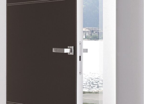A partially open ECLISSE Door system - Syntesis® Hinged Single With Door, featuring a sleek metal handle and minimalist dark finish with white trim, reveals a view of water and buildings outside through a large window.