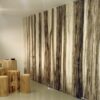 A modern room with a black and white forest mural, tree trunk stools and table, complemented by the seamless ECLISSE Door system - Syntesis® Hinged Single With Door for a sleek, woodland-inspired décor.