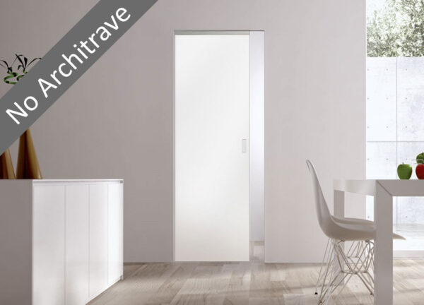 A modern minimal room features the ECLISSE Syntesis® Flush (No Architrave) 10mm Glass Pocket Door System Coloured, complemented by a white sideboard, table, chair, and a fruit bowl. A diagonal label reads “No Architrave.”.