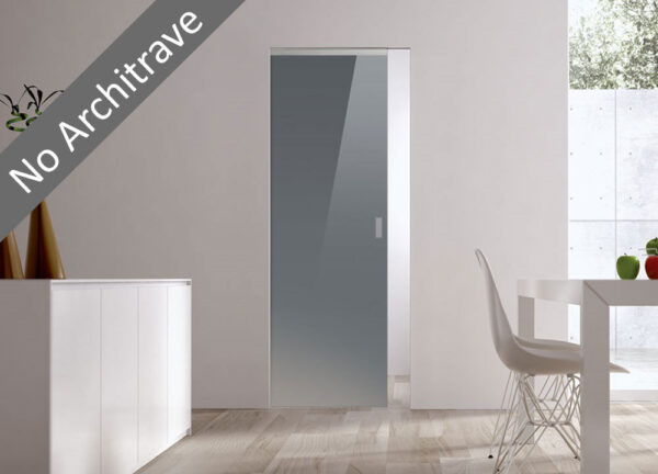 A modern, minimal room features light wood flooring, a white table and chair. The ECLISSE Syntesis® Flush (No Architrave) 10mm Glass Pocket Door System Coloured adds a seamless sliding entry to a bright space, enhancing the clean look.