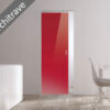 A modern, minimal room showcases the ECLISSE Syntesis® Flush (No Architrave) 10mm Glass Pocket Door System Coloured in red, set in a plain white wall. A white dining table, chair, and a plant complete the clean, understated aesthetic.