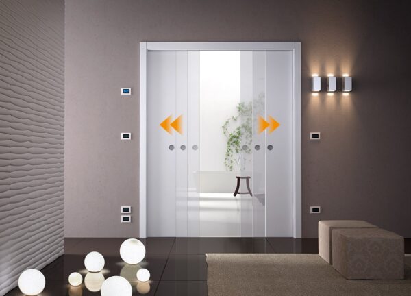 A modern room with ECLISSE Co-ordination Kit for Classic Double Door System, partially open to reveal a white bath and green plant, textured wall, glowing wall lights, round floor lights, and cube-shaped seating.