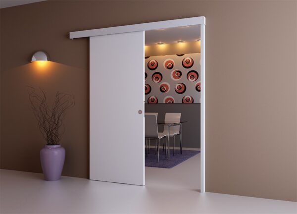 A modern room features a partially open ECLISSE Wall Mounted Sliding Door Kit, Pelmet and Door Post-2m Track-Paris 3, revealing a dining area. The space includes bold circular-patterned wallpaper and a purple vase with dried branches near a wall light.